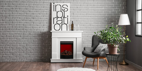 Interior of modern living room with armchair, houseplant and fireplace