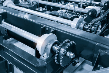 Gear chain drive shaft in conveyor belt is on production line. Timing chain of car, tensioners in...
