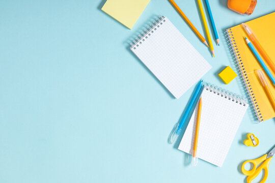 Back to school concept. School accessories on blue background. Flat lay, top view, copy space