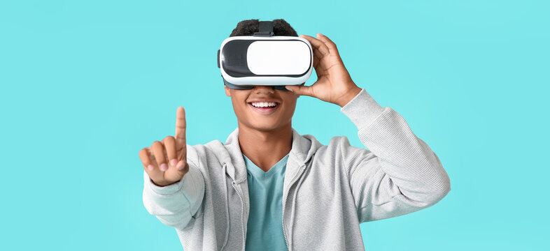 Teenage African-American Boy With Virtual Reality Glasses On Light Blue Background