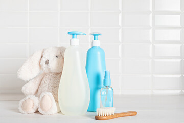 Set of baby toiletries, child organic hygiene and bath accessories, shower gel, shampoo, essential oil, towel in the bathroom