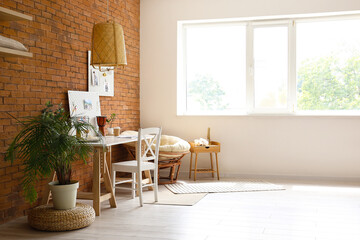 Interior of modern office with workplace, peg boards and houseplants