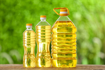 Bottles of sunflower oil on table outdoors