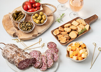 Appetizers table with different antipasti, charcuterie, snacks, cheese. Finger food for buffet party. Traditional french or italian entires. Top view