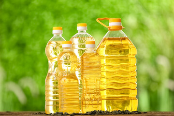 Bottles of sunflower oil on table outdoors