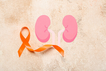 Fototapeta na wymiar Orange awareness ribbon and paper kidneys on grunge background