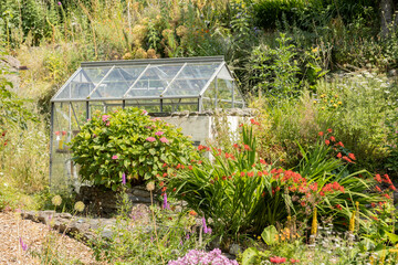 Greenhouse overlooking a beautiful cottage flower garden