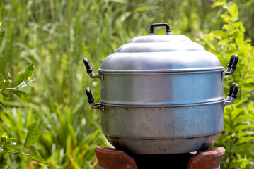 Stainless steamer on charcoal stove