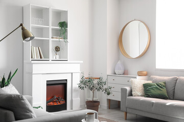 Electric fireplace and shelving unit in interior of light living room