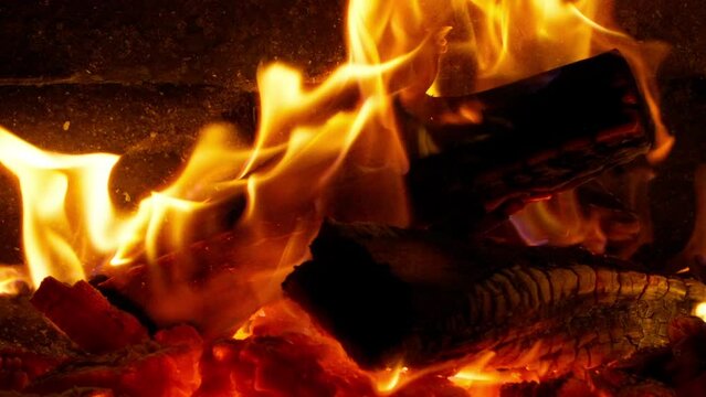 Very cozy room with fireplace close up in slow motion. Pleasant homely atmosphere. Wood burning in the fireplace. Soothing ambience for relaxation shot on cinema RED camera. Bright orange red flames