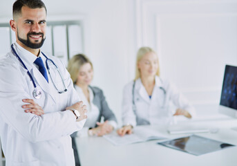 Fototapeta premium Happy doctor with medical staff at the hospital