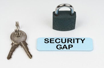 On a white surface there is a lock, keys and a blue sign with the inscription - Security gap