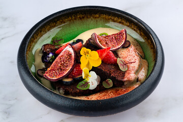 Chocolate cake with figs, blueberries and brownie Closeup