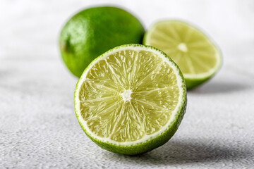 Green lime with cut in half and slices isolated on white background.Healthy green foods -...