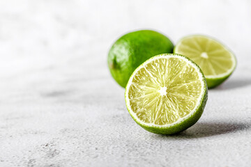 Green lime with cut in half and slices isolated on white background.Healthy green foods - alternative medicine involve a balanced diet with vitamins, nutritions and superfoods for human well-being.
