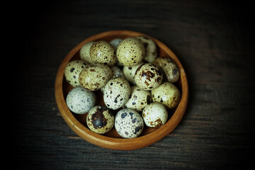 Fresh quail eggs close up on a wooden table small hard boiled eggs rustic top view