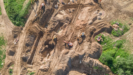Aerial view of excavators on earthwork at construction site. Earthworks during the install of storm sewers. Sanitary sewer.