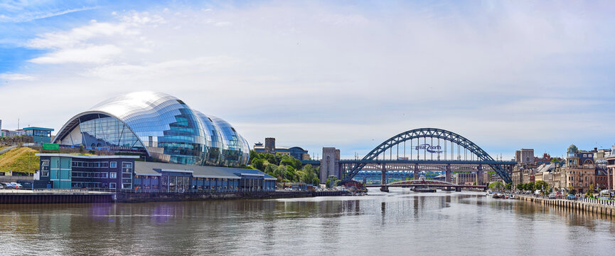 Newcastle upon Tyne, UK, 11 July 2022 - City panorama of Newcastle. Image of the Sage concert hall and the Tyne bridge. View of the city from the River Tyne.