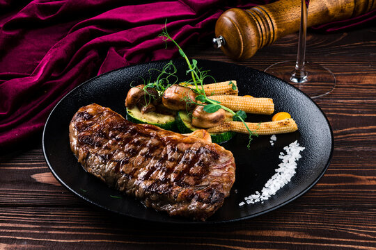 Grilled striploin steak with spices and herbs, strip steak New York strip.