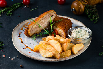 Crispy deep fried home made chicken Cordon bleu with cheese and ham and french fries