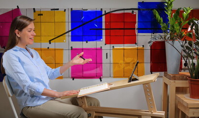Woman designer doing online learning or teaching and working with color palette.