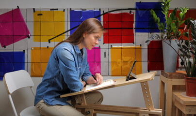Designer woman working at home with color palette