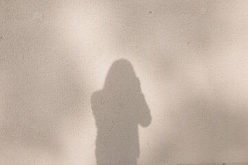 shadow on wall of man with camera
