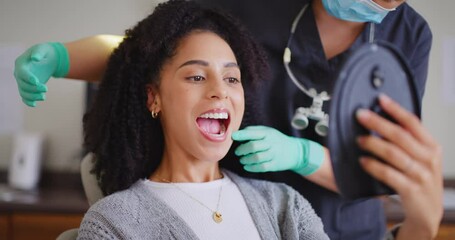 Dentist showing female patient mirror to check her teeth after whitening at dental appointment. Woman having checkup to prevent tooth decay and gum disease. Good oral hygiene for healthy teeth - Powered by Adobe