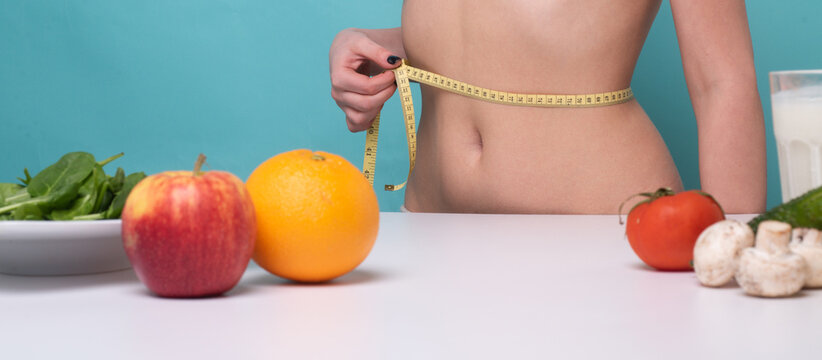 Woman Measuring Her Weist. Diet, Healthy Eating, Food And Weigh Loss Concept.