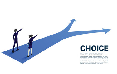 Silhouette of businessman and businesswoman point finger ahead to the crossroad. Concept of time to make decision in business direction