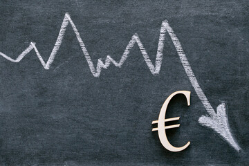  euro currency rate. Euro inflation.Euro sign and a white down arrow on a black background....