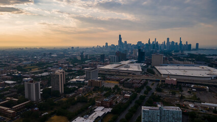 establishing aerial drone footage of a Chicago neighborhood downtown. the city beautiful architectural is also covered by lush green trees throughout creating a welcoming view for tourist