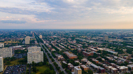 establishing aerial drone footage of a Chicago neighborhood downtown. the city beautiful architectural is also covered by lush green trees throughout creating a welcoming view for tourist