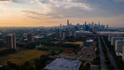establishing aerial drone footage of a Chicago neighborhood downtown. the city beautiful architectural is also covered by lush green trees throughout creating a welcoming view for tourist
