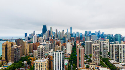 Fototapeta na wymiar establishing aerial drone footage of a Chicago neighborhood downtown. the city beautiful architectural is also covered by lush green trees throughout creating a welcoming view for tourist