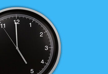 Wall clock showing five o'clock on blue background. Copy space