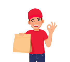 Young handsome delivery service man in red cap t-shirt uniform holding box parcel showing ok hand sign gesture