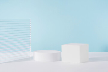 Acrylic plate, podium, background for cosmetic product packaging on blue backdrop with stylish...