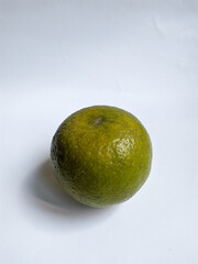 green fresh orange fruit on white paper or background. Suitable for your orange product.