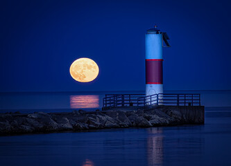 Moon rising next to pierhead light - 517576330