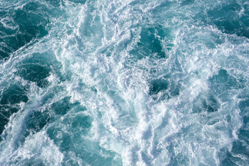Fototapeta na wymiar Water abstract background. Cruise ship wake while leaving the pier in Hawaii 