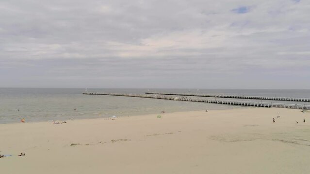 Pier van Nieuwpoort, Wooden Fishing Pier With Sandy Beach In Nieuwpoort, Belgium. - aerial wide