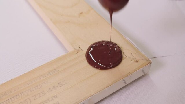 Close-up of stamping with sealing wax on the wooden picture frame.