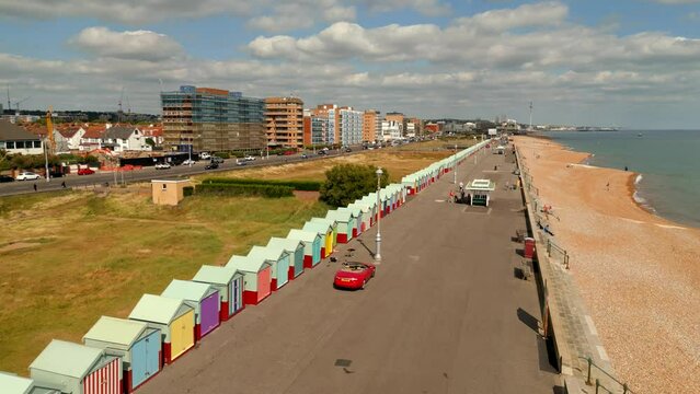 Brighton Beach Hove Beach Huts painted colorful. 4k aerial drone video UK