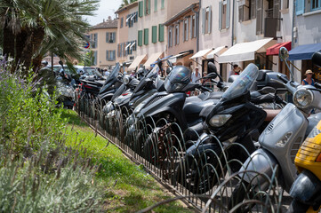 Street parking of motors in Saint Tropez, village on Mediterranean sea with yacht harbour, Provence, France