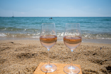 Cold rose wine from Provence served outdoor on white sandy beach Plage de Pampelonne near Saint-Tropez, France