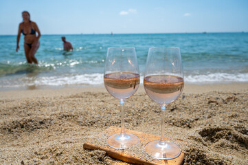Cold rose wine from Provence served outdoor on white sandy beach Plage de Pampelonne near Saint-Tropez, France