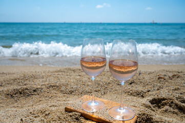 Cold rose wine from Provence served outdoor on white sandy beach Plage de Pampelonne near Saint-Tropez, France