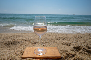 Cold rose wine from Provence served outdoor on white sandy beach Plage de Pampelonne near Saint-Tropez, France