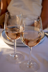 Dinner at sunset in French restaurant with cold dry rose wine in Port Grimaud, summer vacation on French Riviera, France